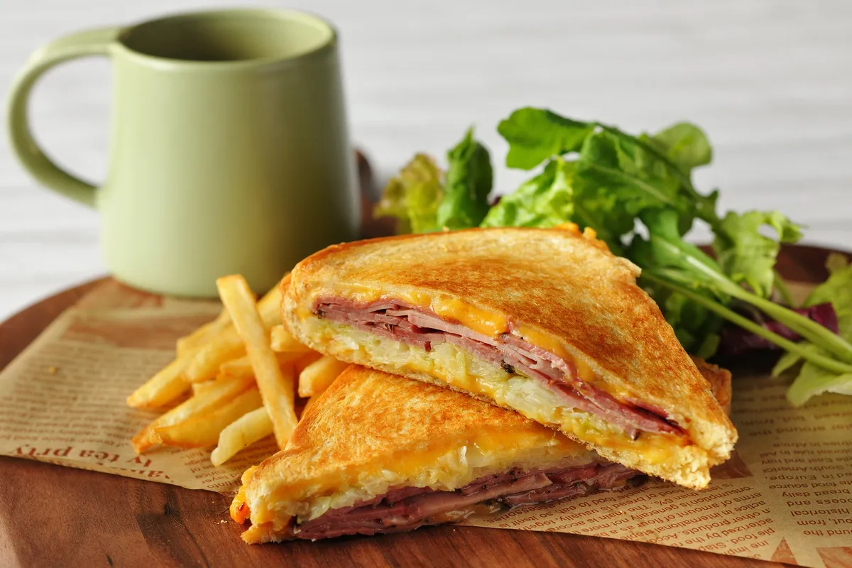 Freshly grilled Reuben sandwich with fries