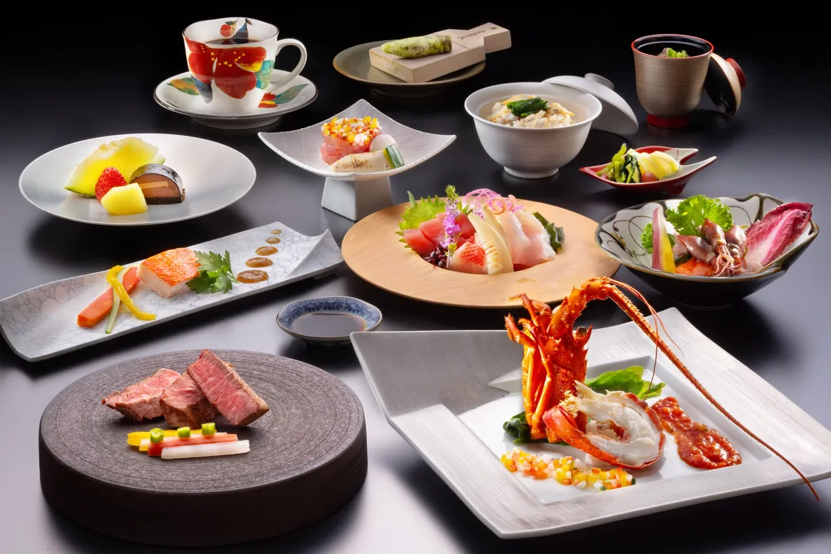 A multi-course meal featuring lobster and sashimi