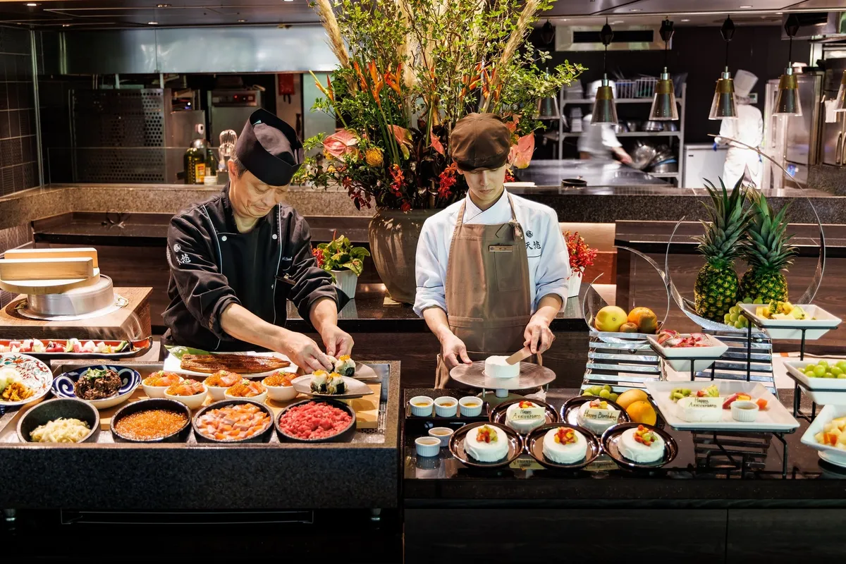 Chefs preparing seafood and desserts at the buffet counter