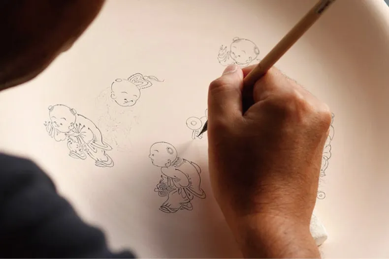 A hand painting traditional figures on a porcelain plate