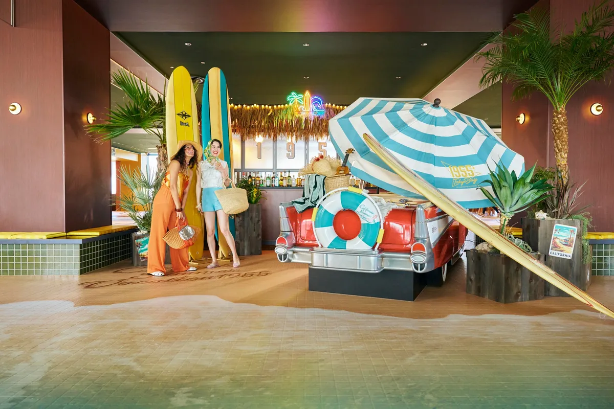 1950s surf-culture decor featuring a vintage car and surfboards