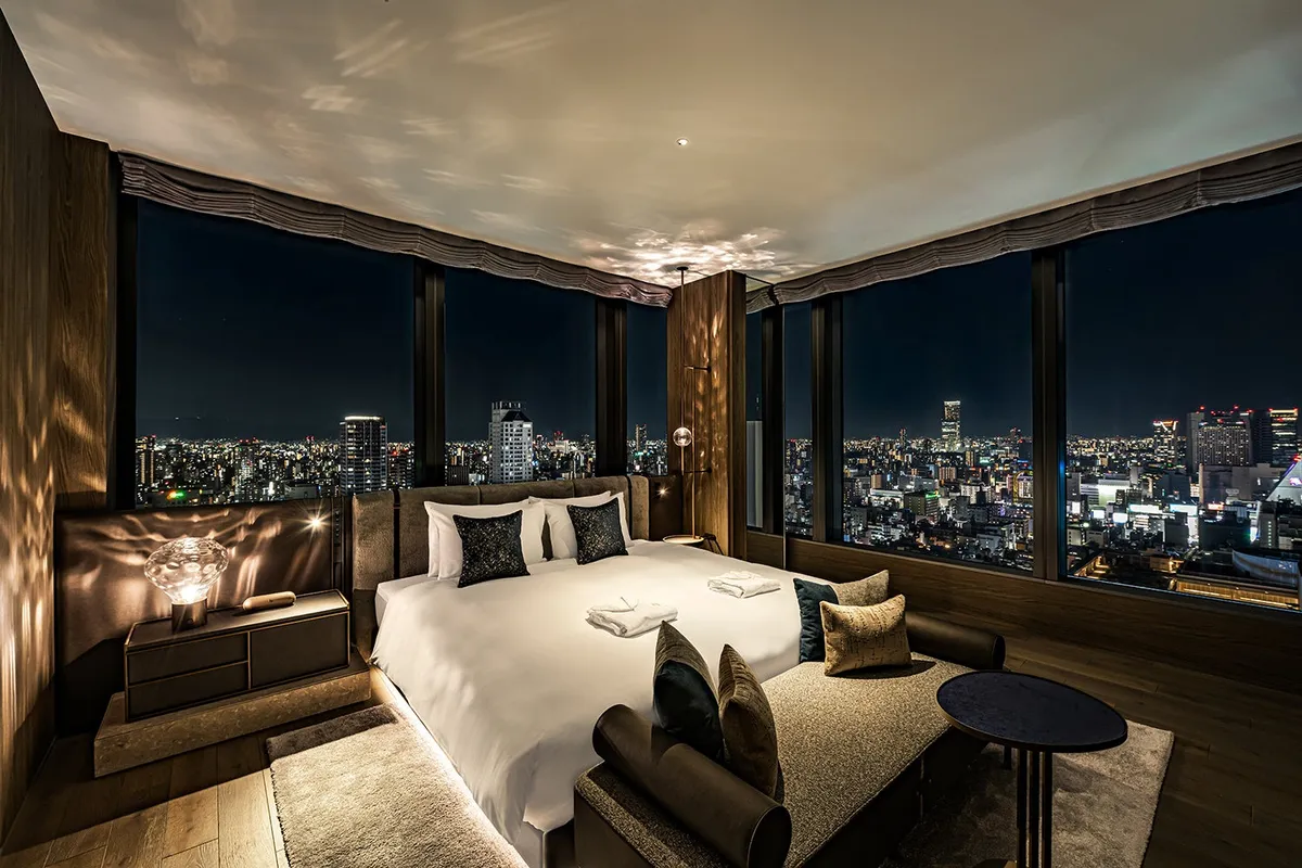 Guest room with corner windows overlooking the Osaka city lights