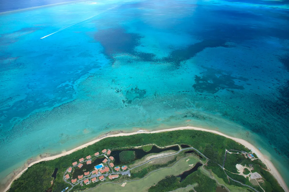 Aerial view of the clear blue sea surrounding Kohama Island