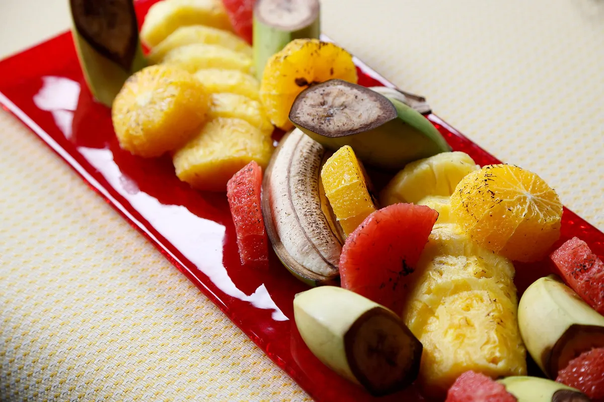 A platter of fresh tropical fruits including pineapple and banana