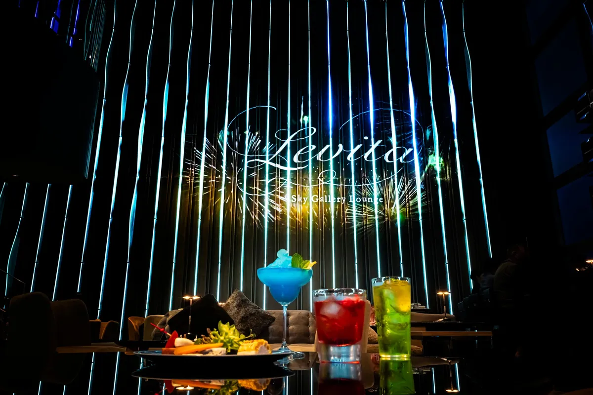 Digital firework projections on the lounge walls with cocktails in the foreground