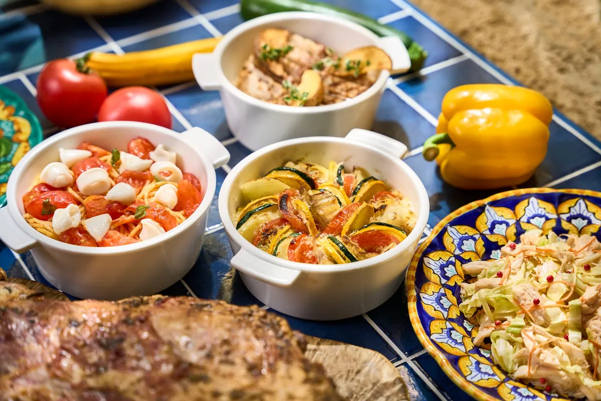 Bowls of Italian pasta and vegetable dishes