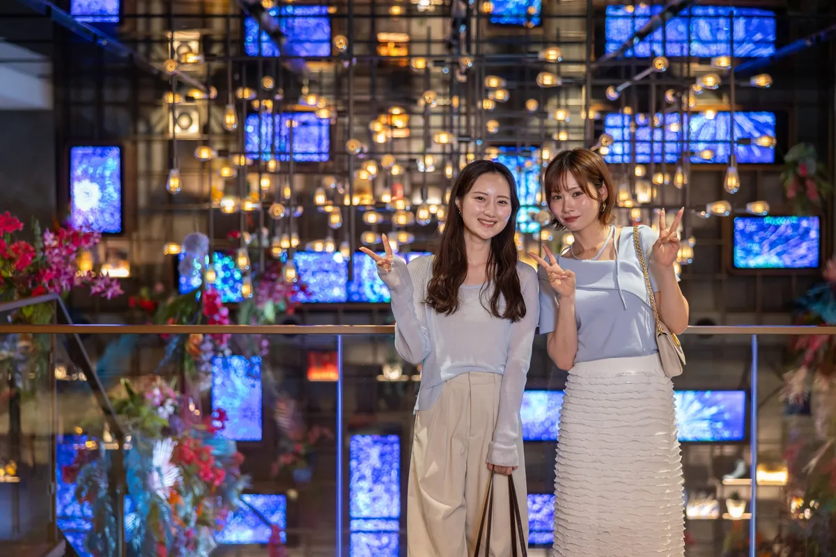 Guests posing in front of the digital art wall