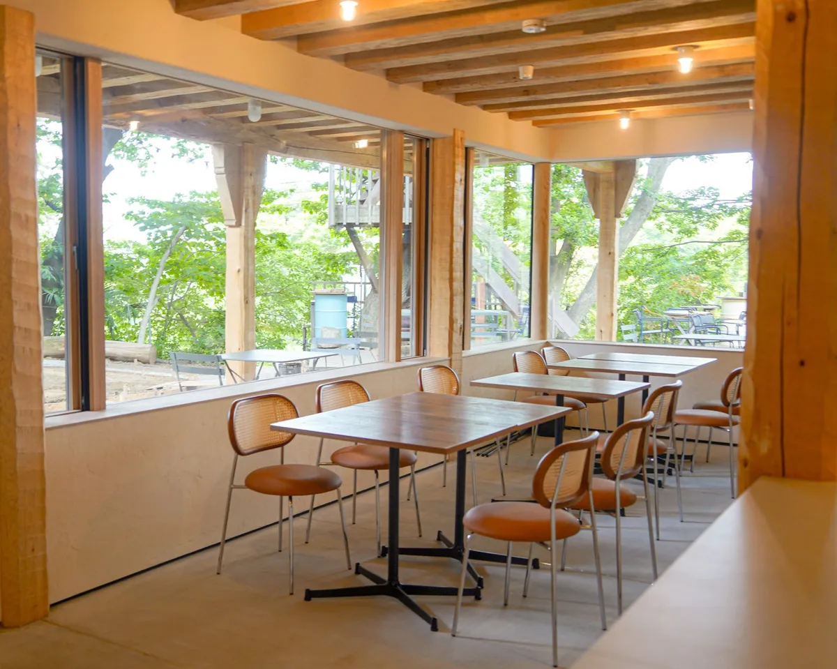 The permanent indoor dining space with forest views