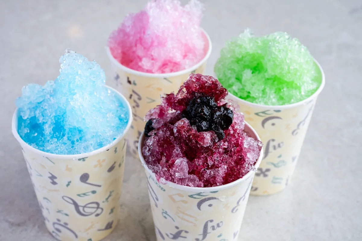 Four cups of colored shaved ice made with spring water