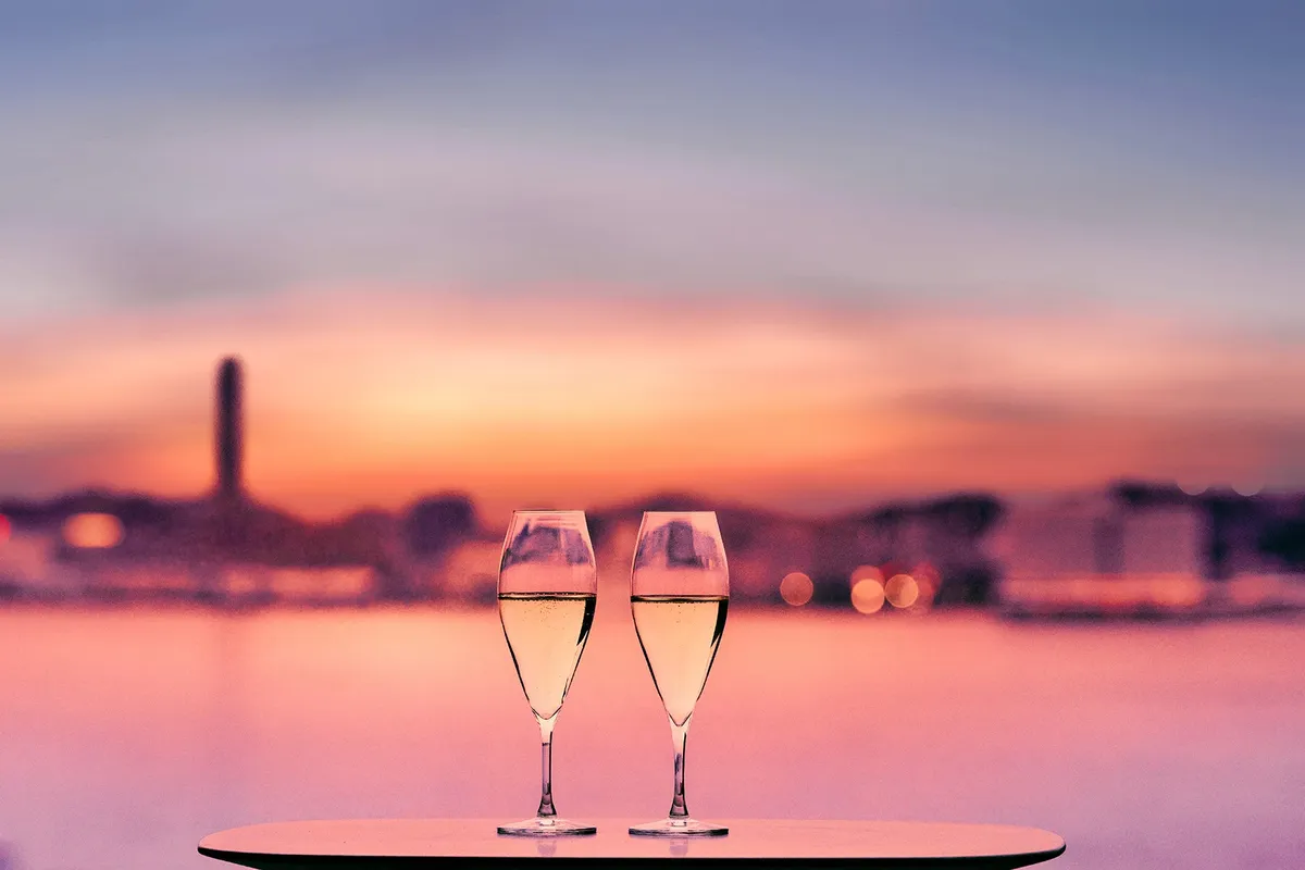 Two glasses of sparkling wine at sunset