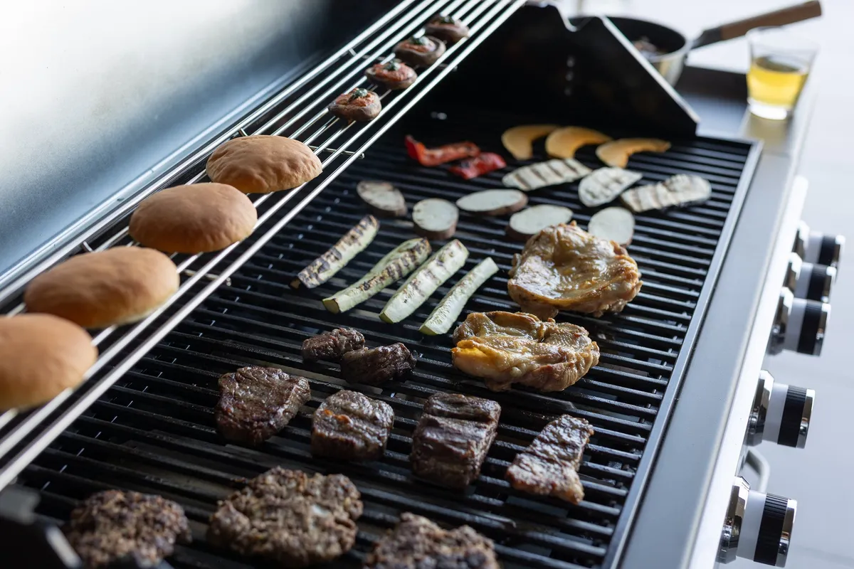 Meat and vegetables on a professional BBQ grill