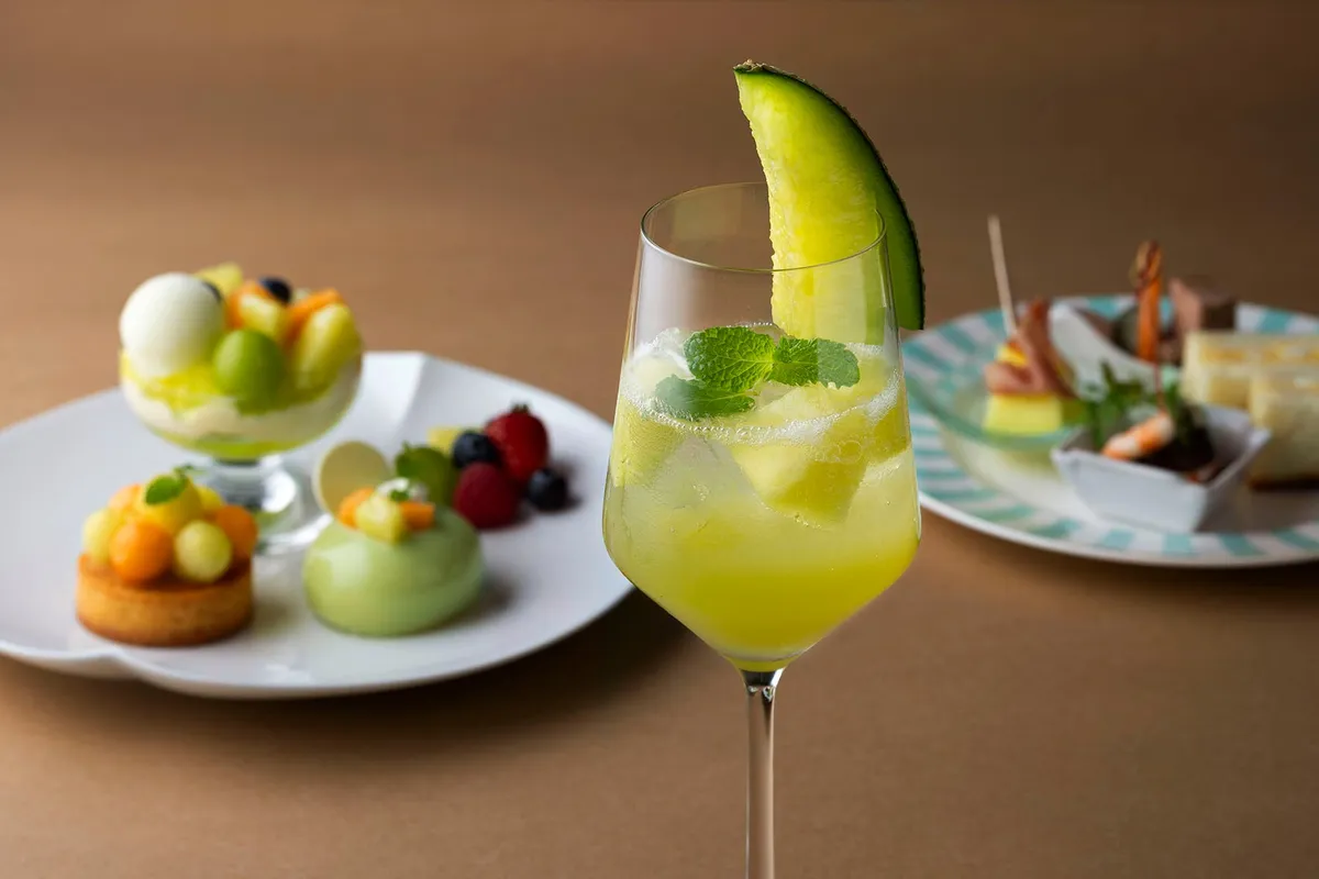 Melon Squash beverage garnished with a fresh melon slice