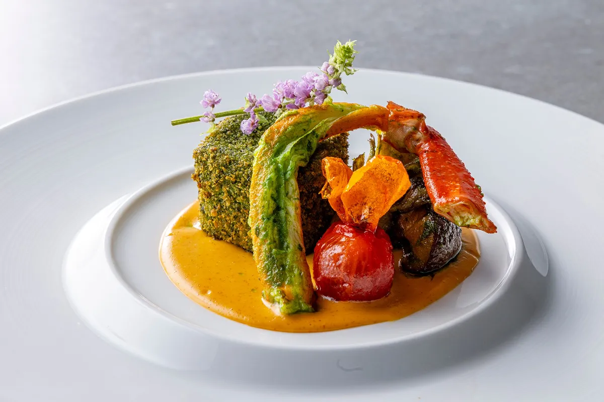 Herb-crusted meat dish with crab