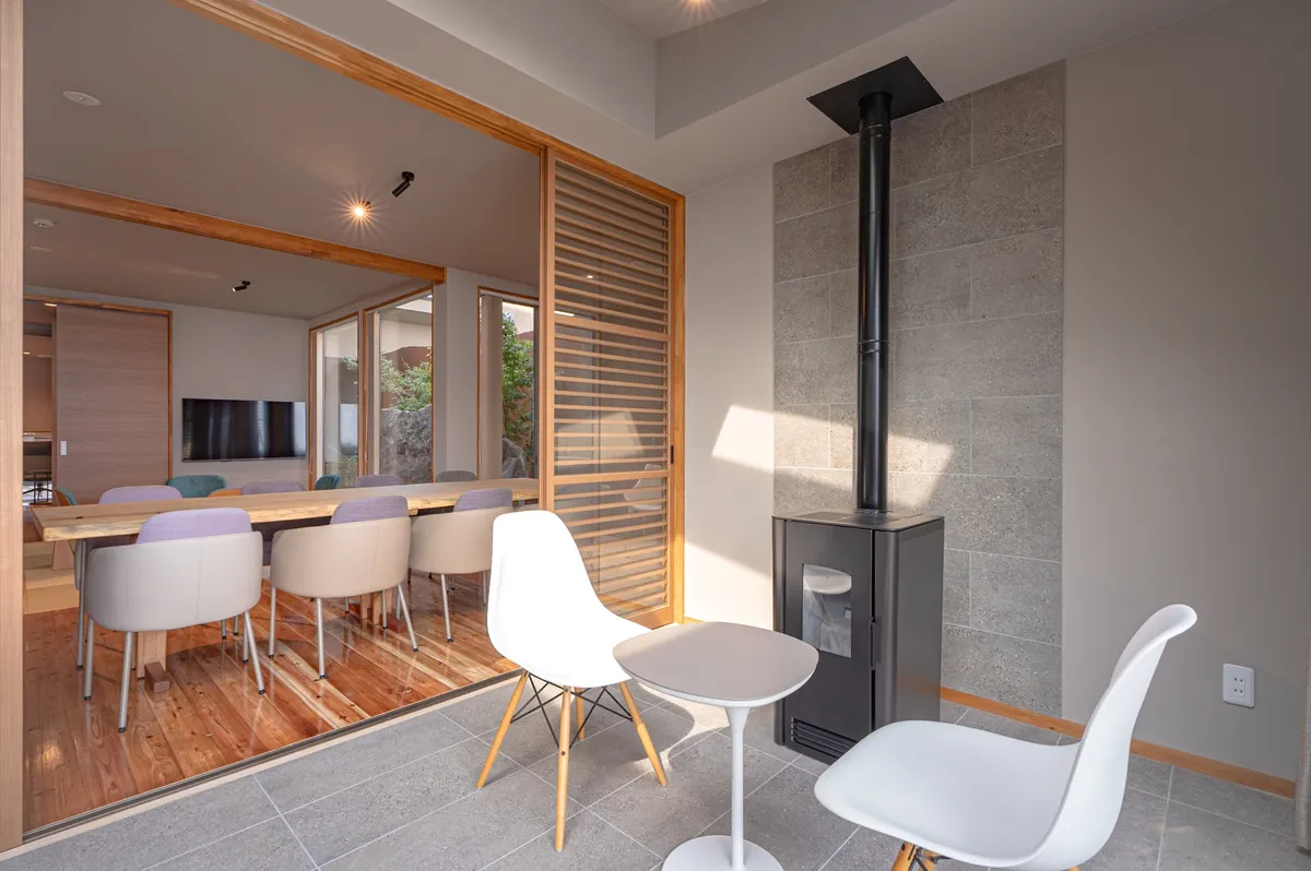 A sheltered terrace area equipped with a wood-burning stove.