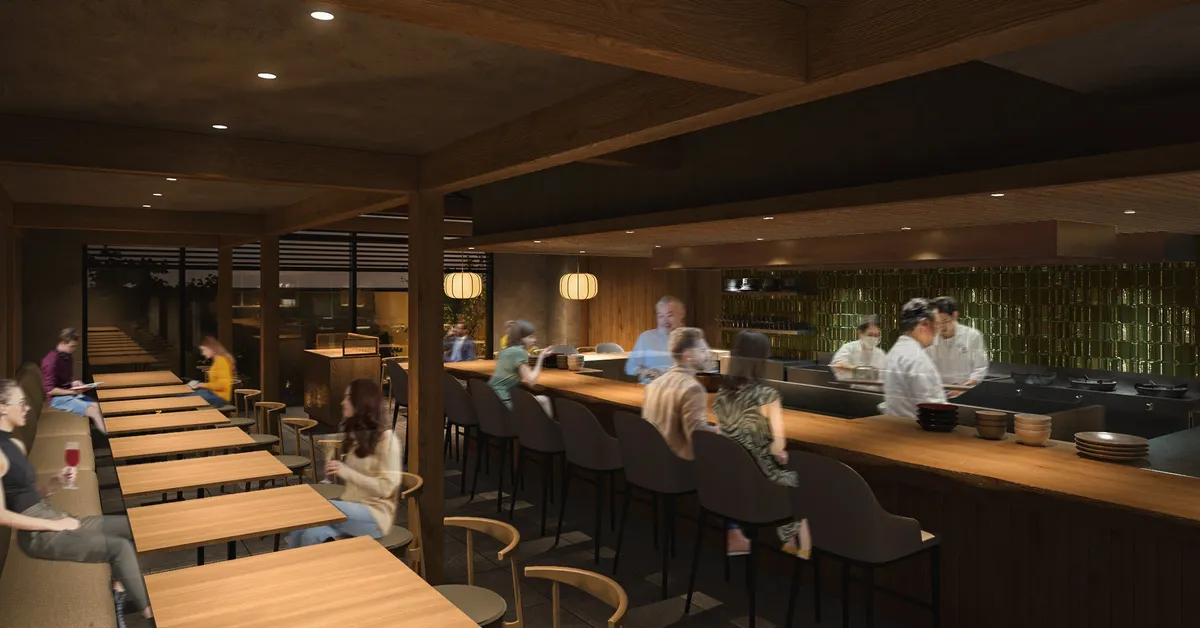 The interior of the new restaurant with a long wooden counter and open kitchen