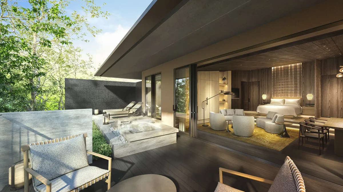 A luxury villa with a large outdoor terrace and a private stone hot spring bath