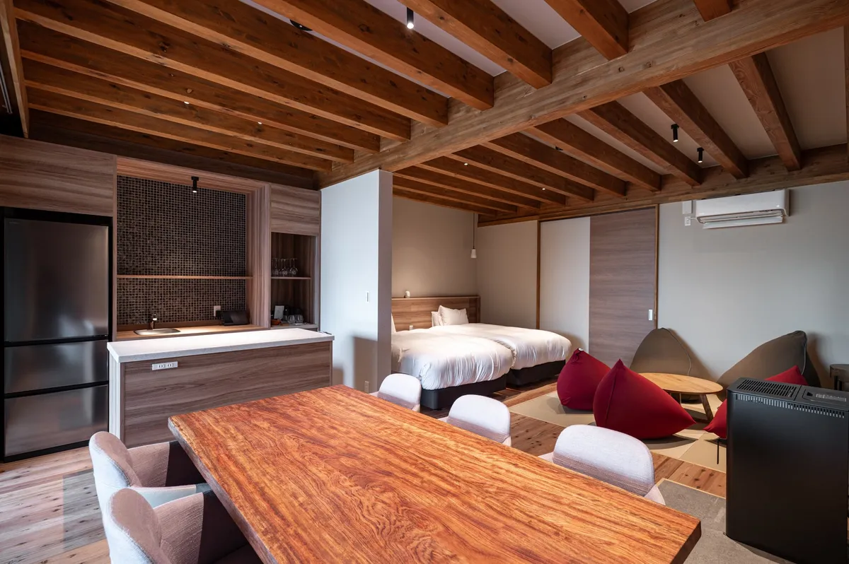 A villa interior featuring exposed timber beams and beanbag seating.