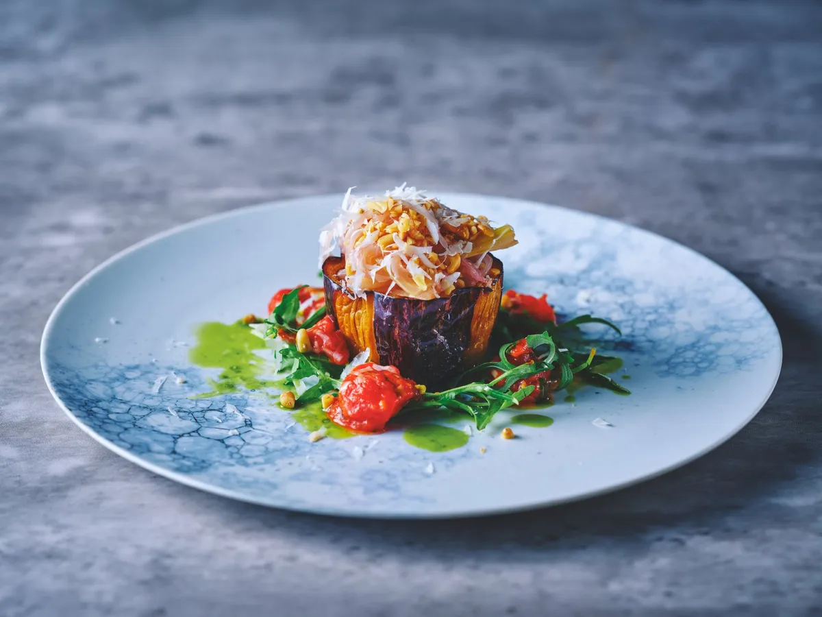 Roasted eggplant with tomatoes and greens