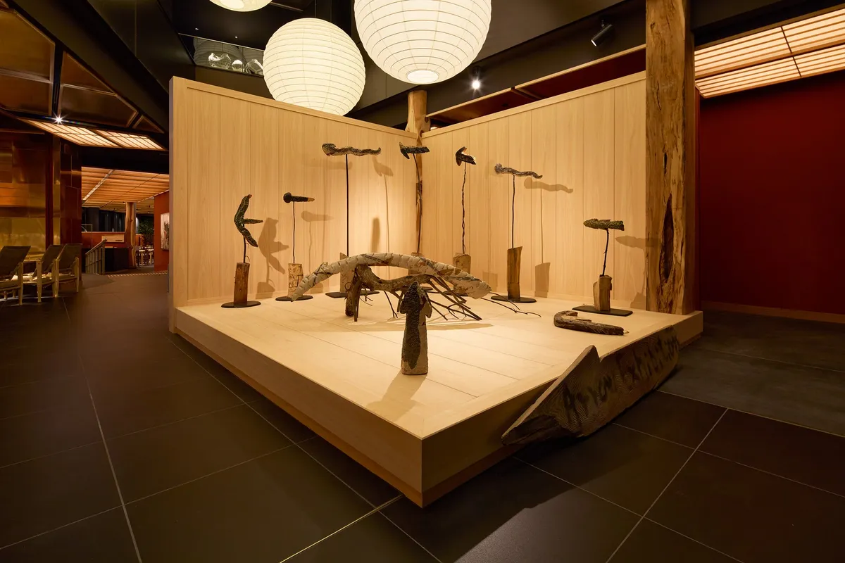 A contemporary art installation under paper lanterns