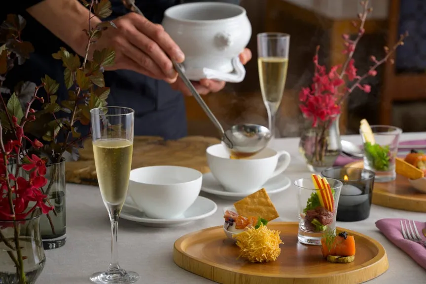 A server pouring venison consommé