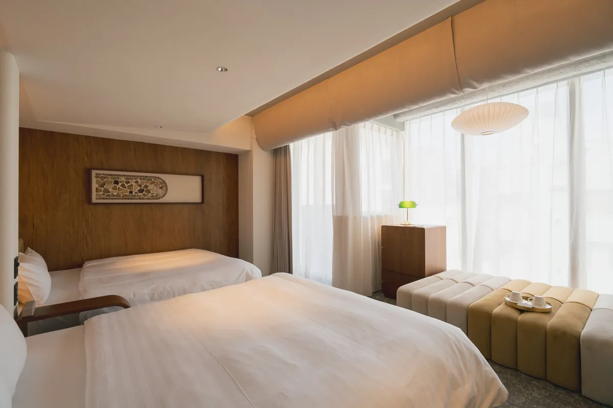 Deluxe Twin room with two queen beds and minimalist decor