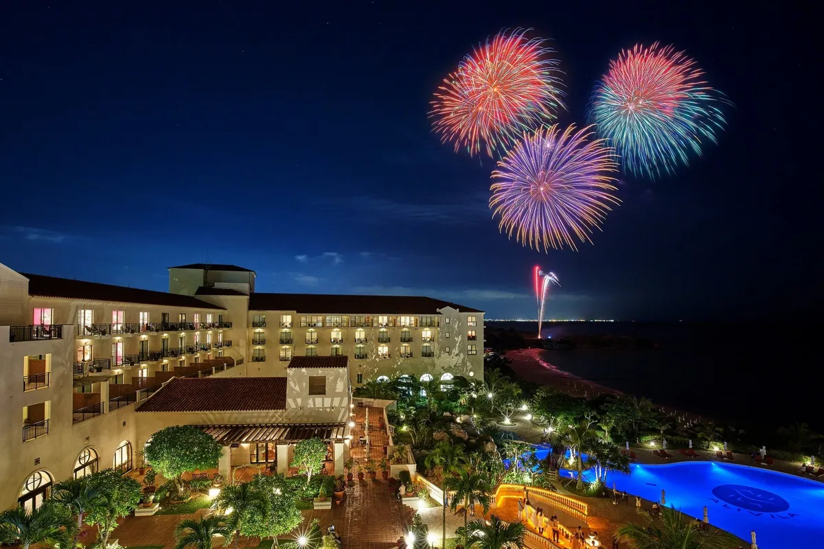 Fireworks exploding over Hotel Nikko Alivila at night