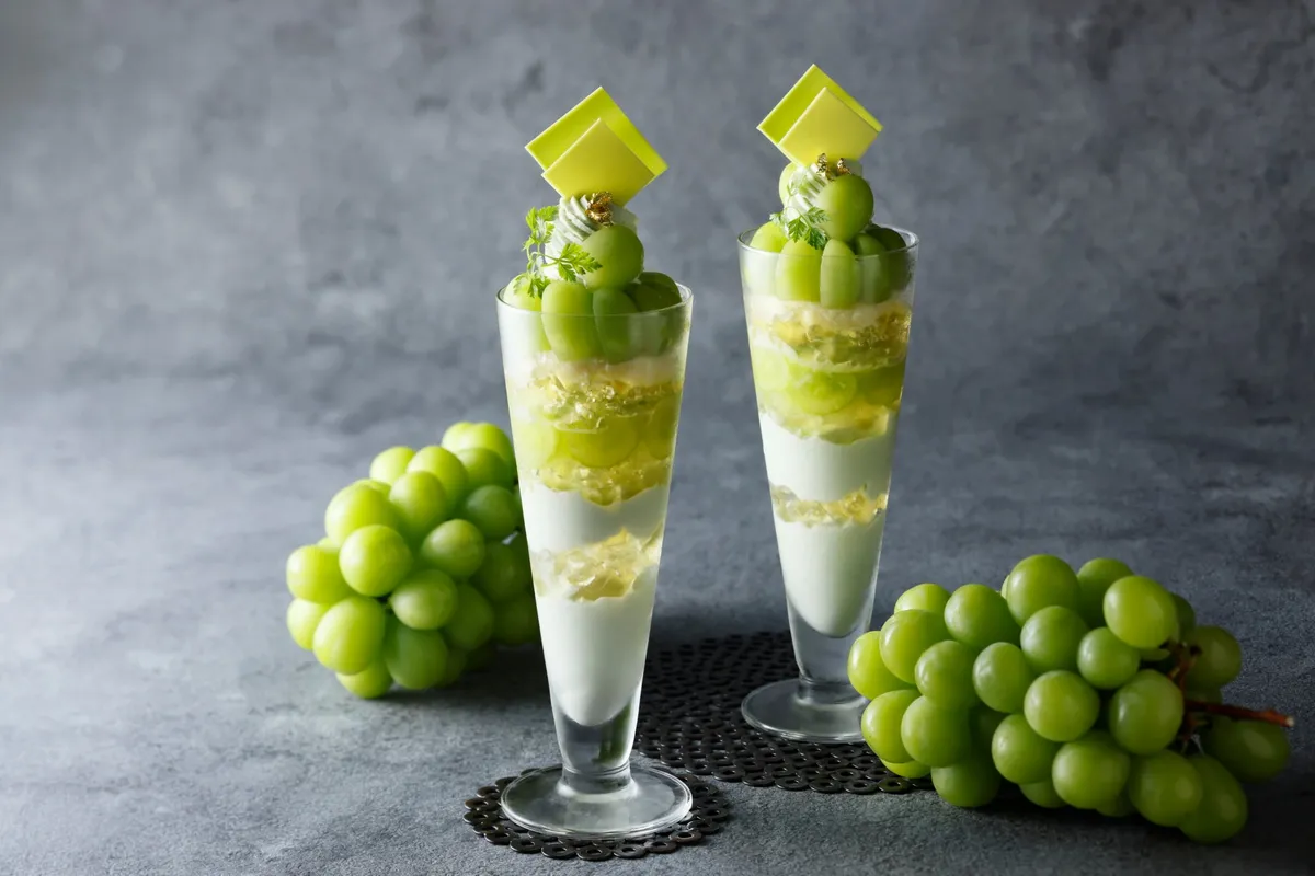 Two Shine Muscat Autumn Reward Parfaits served alongside fresh bunches of grapes