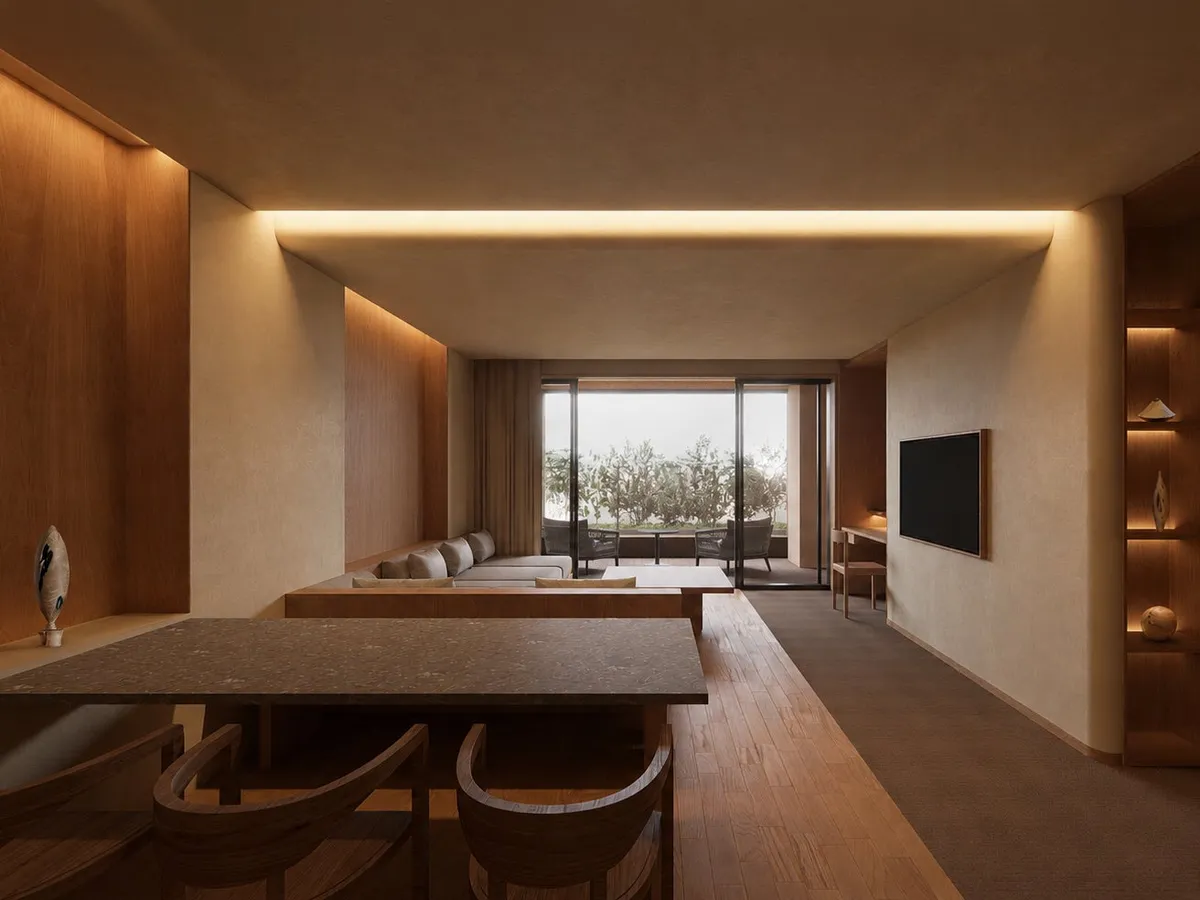 A spacious guest suite with modern furnishings and a view toward the terrace.