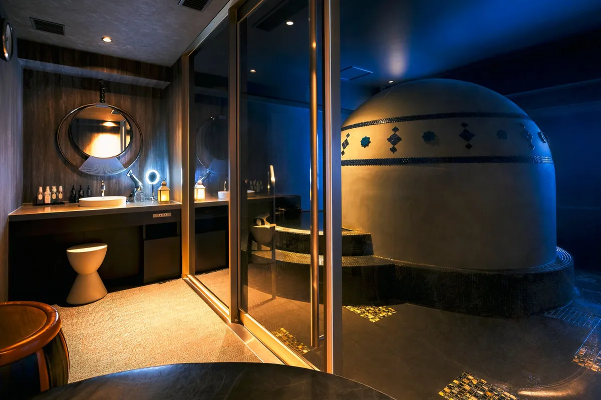 The private bathing suite featuring a vanity and the meditative pool.