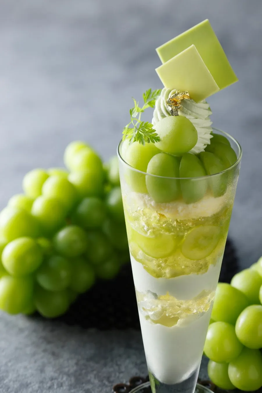 Close-up of the layered Shine Muscat parfait featuring gold leaf and light green chocolate