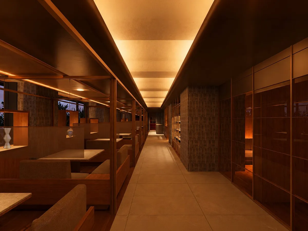 The dining area featuring private booths and warm, indirect illumination.