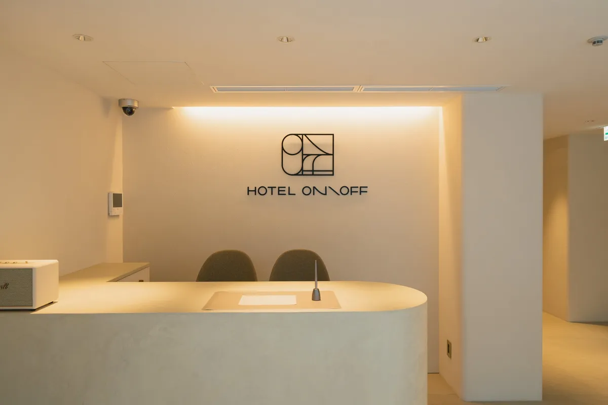 Minimalist front desk with rounded edges and soft lighting