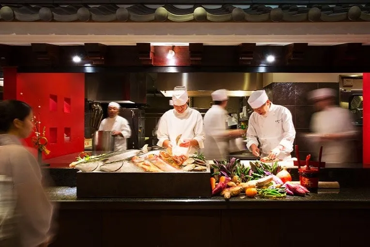 Chefs preparing seafood at the ryokan kitchen