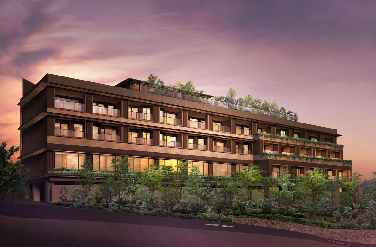 An exterior rendering of the five-story hotel nestled into the hillside at dusk.