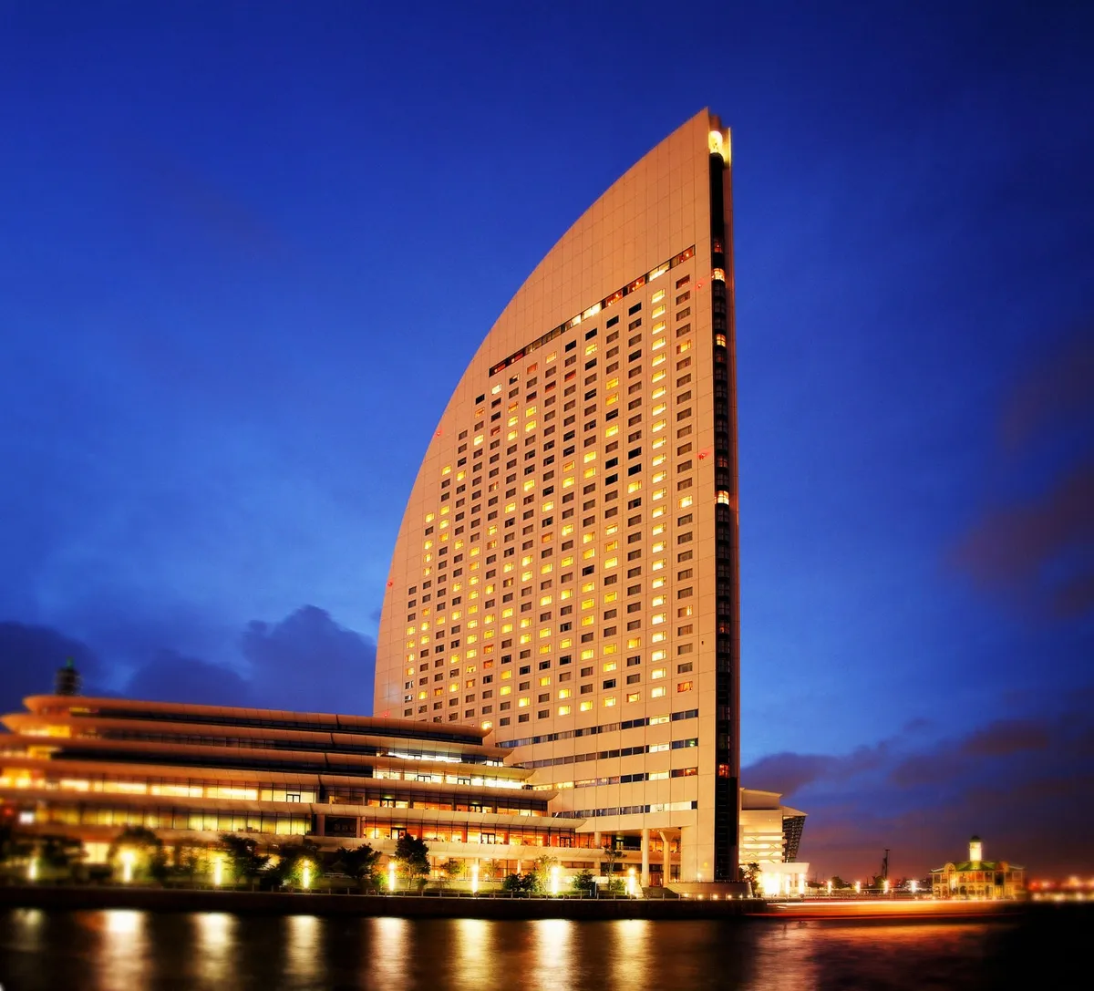 The sail-shaped exterior of the hotel at night