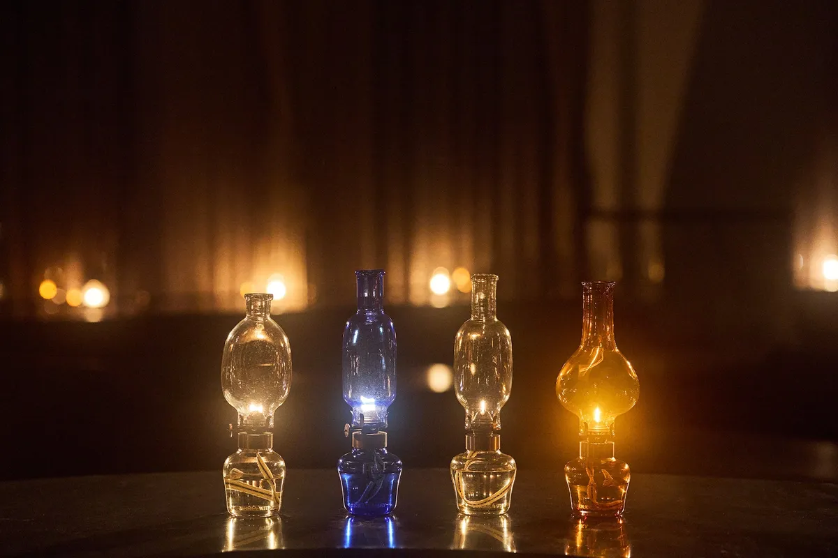 Four custom-made glass oil lamps in different colors