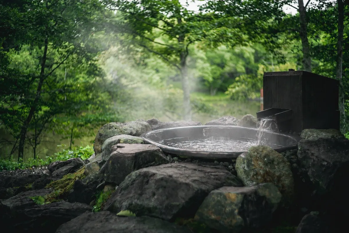 Close-up of a stone open-air onsen bath
